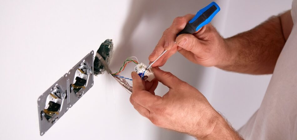 A,person,is,engaged,in,an,electrical,repair,task,at