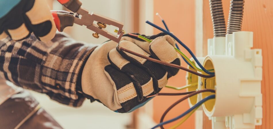 An,electrician,is,focused,on,connecting,colorful,wires,in,a