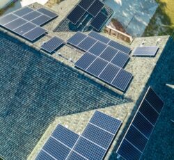 Aerial,view,of,american,home,roof,with,blue,solar,photovoltaic